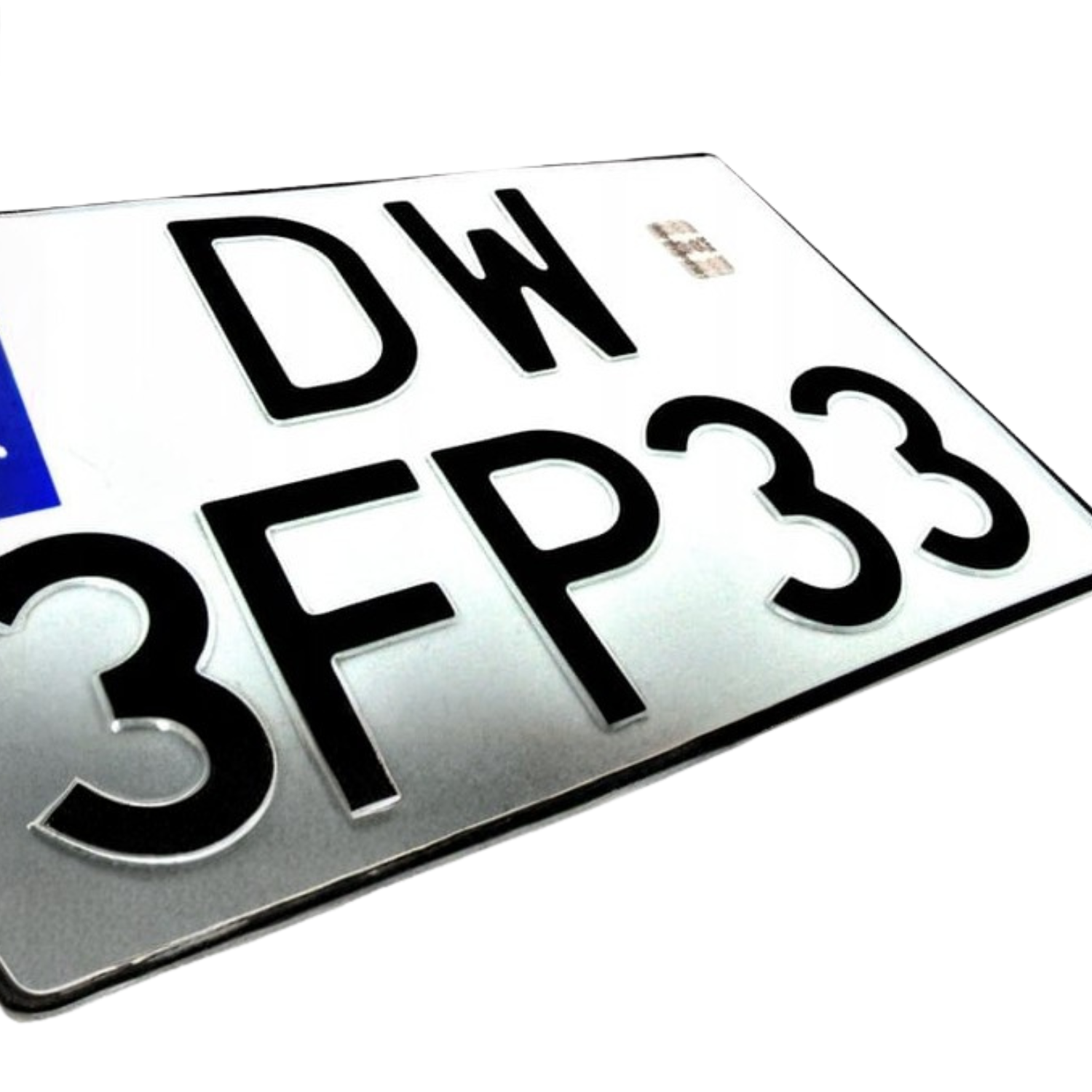 Zbliżenie na białą polską tablicę rejestracyjną z czarnymi, tłoczonymi znakami „DW 3FP33”, przedstawioną pod kątem.